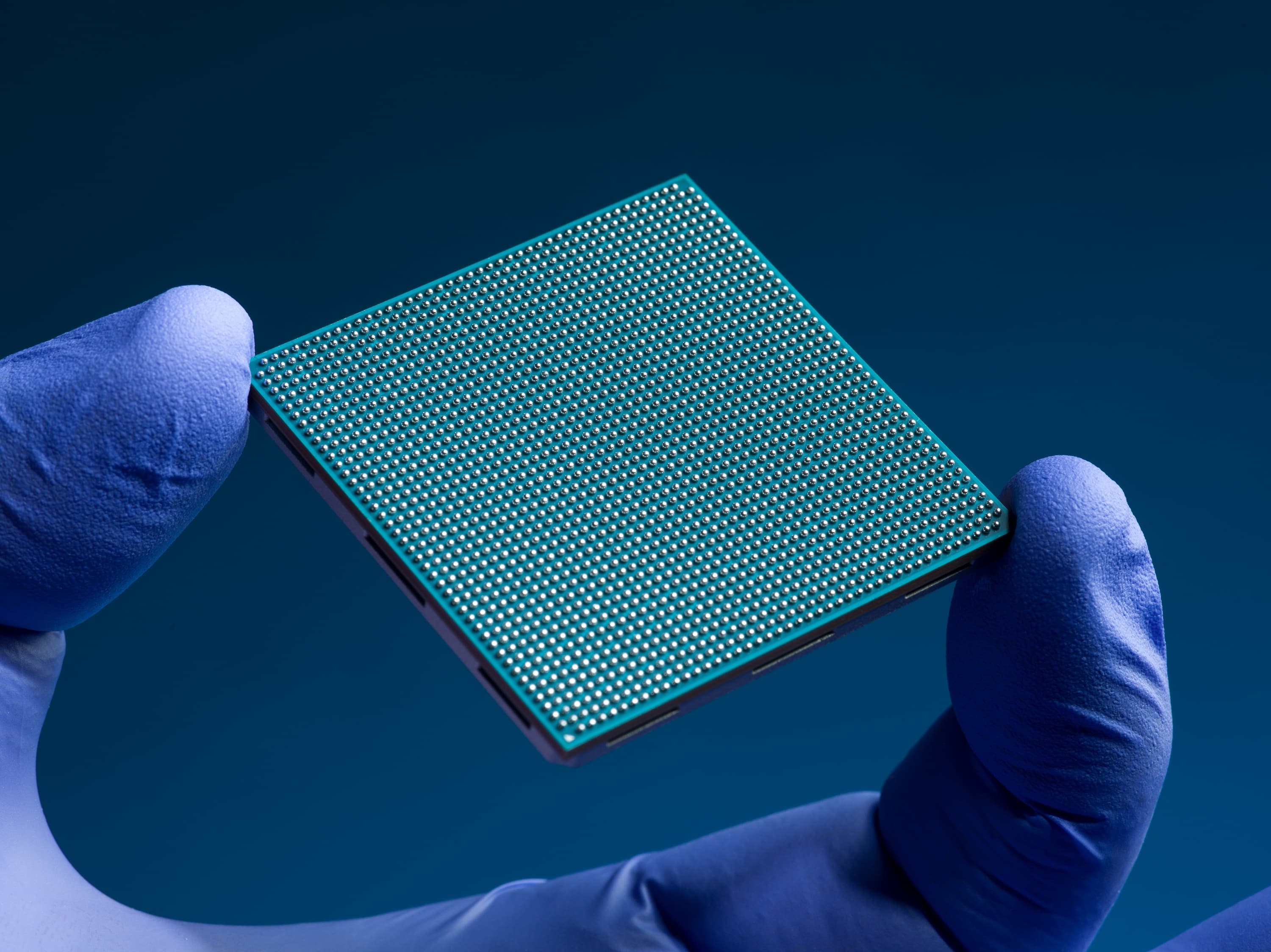 Radiation-hardened processor held by gloved hands during NASA spaceflight computing testing